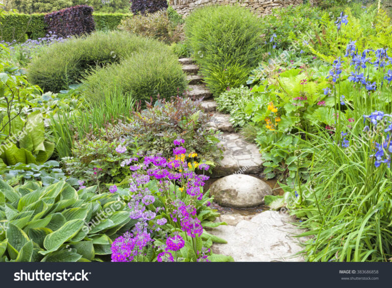 stock-photo-stone-steps-going-up-through-colorful-summer-blue-pink-flowers-green-foliage-ending-at-the-top-383686858